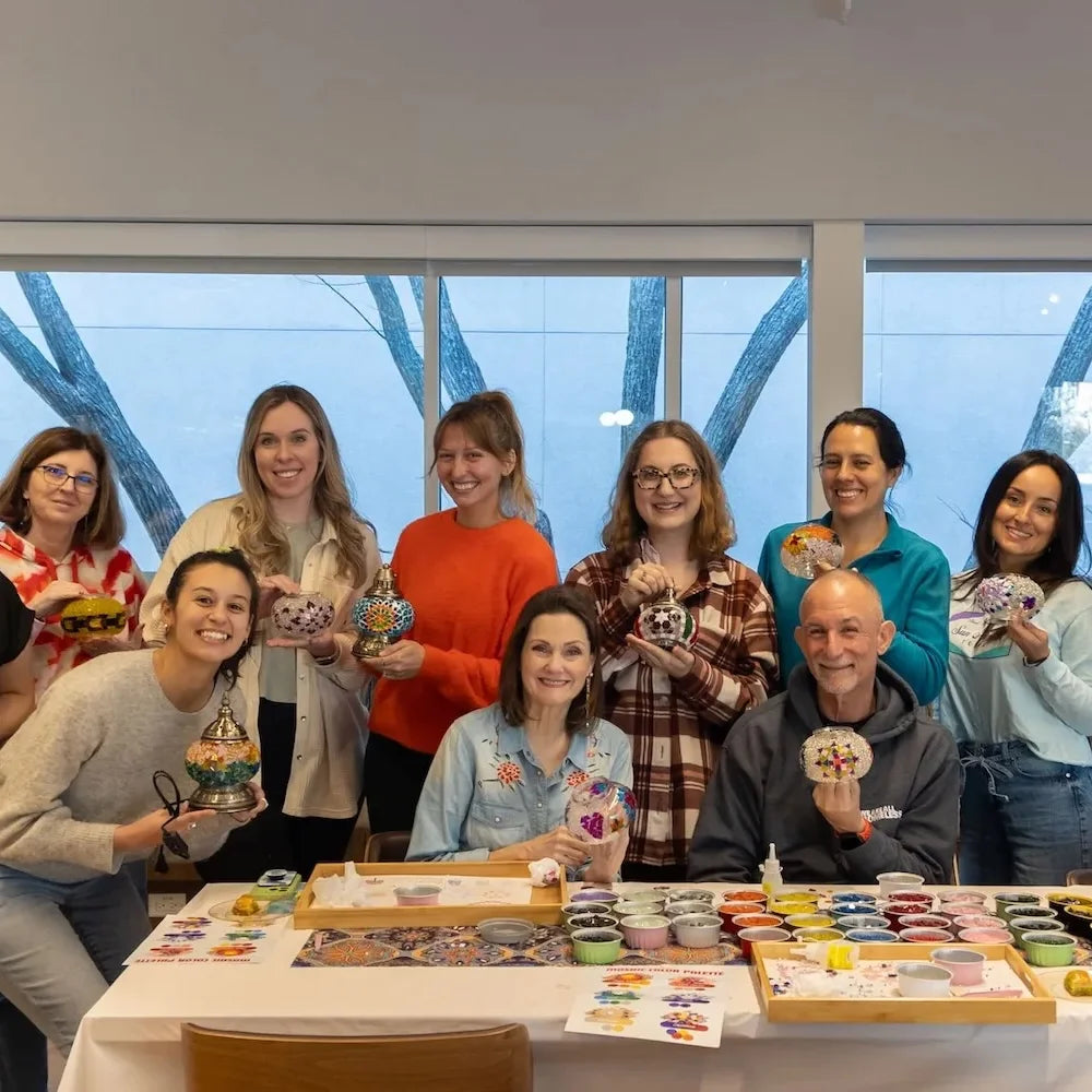 Group of happy participants holding their finished colorful mosaic lamps at Mosaic Lamp Workshop Turkish Mosaic Lamps Tiles Workshop